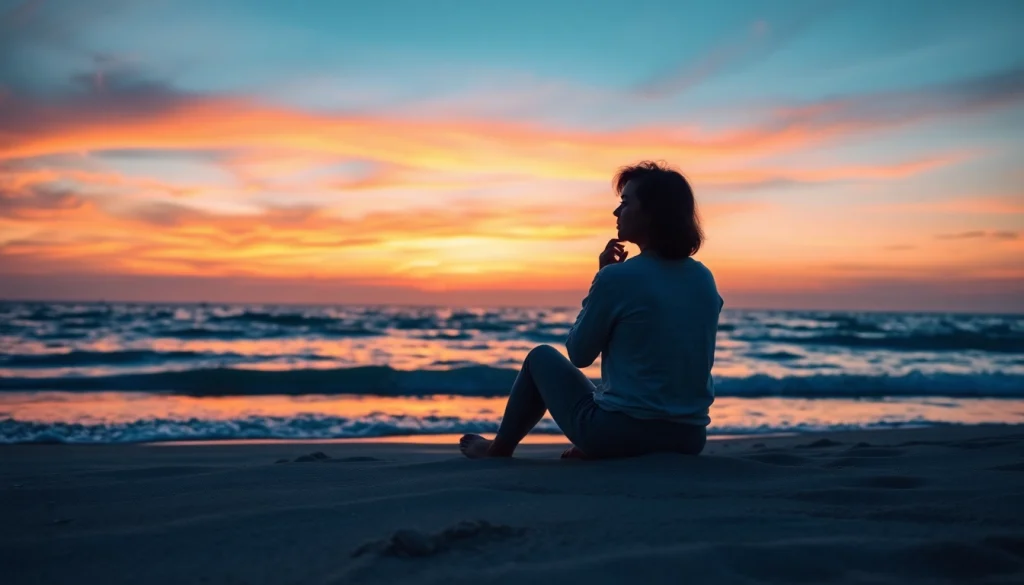 Person reflecting on anxiety symptoms while sitting on a tranquil beach.